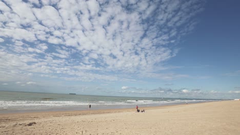 Panoramic-view-of-sea-coast-and-wide-almost-deserted-sandy-beach