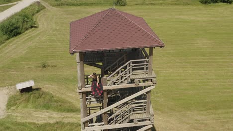 Above-woman-enjoying-view-from-observation-tower-edge