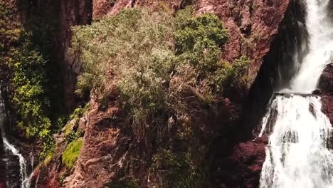 Waterfall-flowing-along-cliff-face-in-Darwin