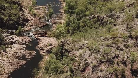 Drone-footage-over-large-lake-in-Kakadu-National-park-flying-towards-multiple-waterfalls