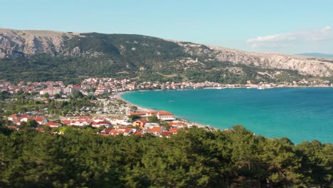 The-Lush-Green-Forest-By-The-Mountains-And-Revealing-The-Beautiful-Ocean-And-Seaside-Town-Of-Baska-In-Krk-Island,-Croatia