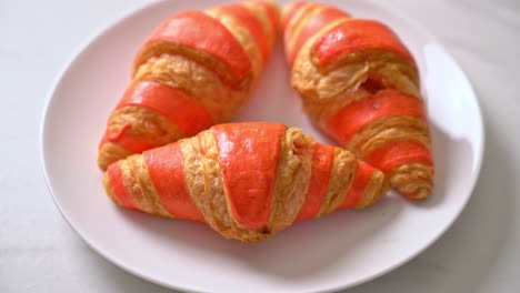 fresh-croissant-with-strawberry-jam-sauce-on-plate