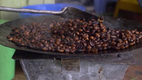 Side-shot-for-the-coffee-beans-being-roasted-and-turned-into-the-dark-color,-this-is-sign-they-are-ready-to-be-turned-into-delicious-drink