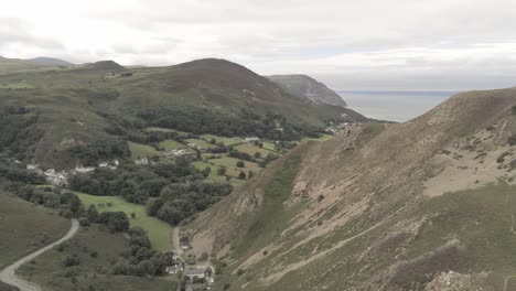 Capelulo-Penmaenmawr-Welsh-mountain-coastal-valley-aerial-view-north-wales-track-right-slow