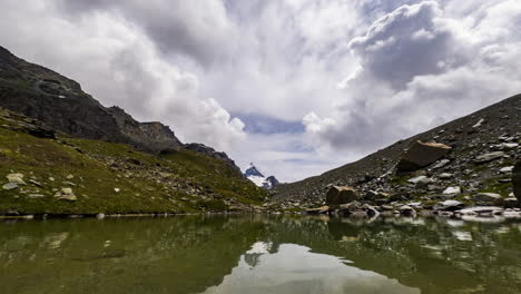 Serene-Water-At-The-Small-Alpine-Lake-With-A-Cloudy-Sky-In-Zermatt,-Switzerland,-Europe-At-Daytime---timelapse