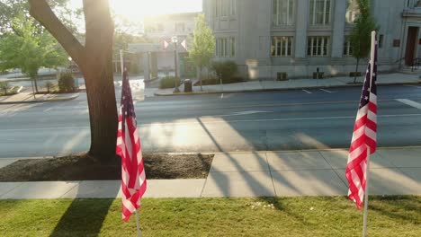 Establishing-shot,-American-patriotism-in-Small-Town-America,-peaceful-calm-turn-reveals-USA-flags