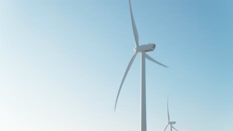 Windmill-turbines-rotating-against-blue-sky