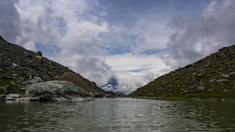 Wind-Blows-Disturbing-The-Calm-Water-In-A-Small-Lake-In-Zermatt,-Switzerland