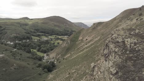 Capelulo-Penmaenmawr-Welsh-mountain-ridge-rising-above-coastal-valley-aerial-view-north-wales