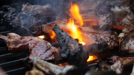 Close-up-of-hot-BBQ-flames-cooking-fresh-ribs-in-slow-motion