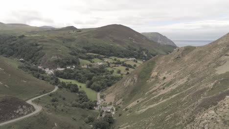 Capelulo-Penmaenmawr-Welsh-mountain-coastal-valley-aerial-view-north-wales-slow-rising-shot