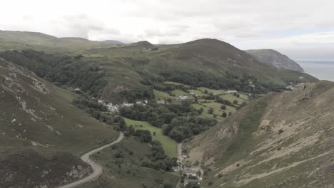 Capelulo-Penmaenmawr-Welsh-mountain-coastal-valley-aerial-view-north-wales-pull-back-slow