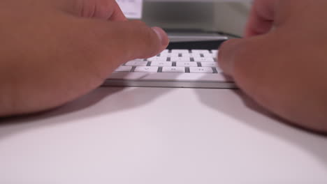 Married-man's-hands-typing-on-keyboard-in-modern-office