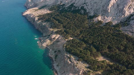 Majestic-Landscape-Of-Rocky-Coastal-Cliffs-By-The-Calm-Blue-Sea-Near-The-Krk-Island-In-Croatia