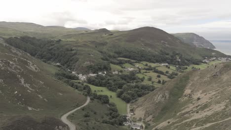 Capelulo-Penmaenmawr-Welsh-mountain-coastal-valley-aerial-view-north-wales-pan-left