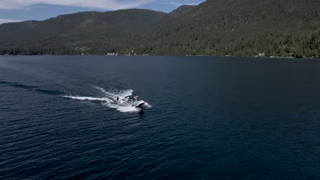 Slow-motion-drone-orbit-around-Wakeboarder-being-pulled-by-speedboat