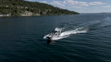 Aerial:-wakeboarding-behind-speedboat-on-Flathead-Lake,-Kalispell,-Montana