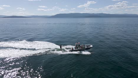 Slow-motion-orbit-of-Wakeboarder-with-sunlight-sparkling,Flathead-Lake