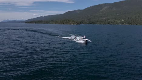 Amazing-wakeboarding-behind-speedboat-on-Flathead-Lake,-Montana,-aerial