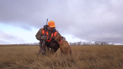 Hunter-calls-his-loyal-retriever-gun-dog-to-his-side,-Saskatchewan-Canada