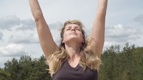 Close-up-of-woman-reaching-to-the-sky