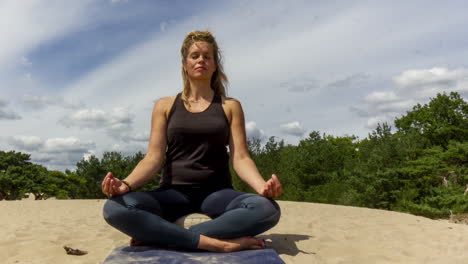Timelapse-of-Woman-meditating-in-sand-dunes---right-to-left