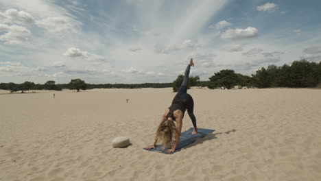 Woman-lifting-right-leg-while-doing-downward-dog-yoga-exercise
