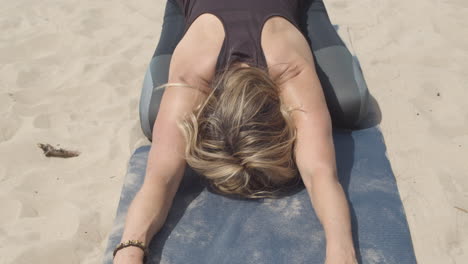 Close-up-of-woman-in-sleeping-swan-yoga-pose