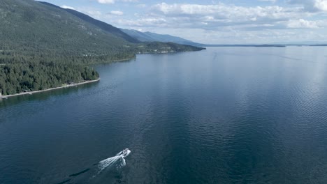 Fresh-Water-Lake-with-Boaters-Enjoying-Summer-Day-in-Kalispell,-Montana---Aerial-Drone