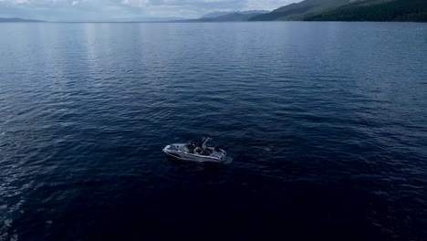 Drone-pull-back-from-speedboat-to-reveal-Montana-lake-and-mountains