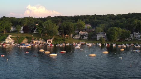 Boats-docked-on-the-lake-shore-of-cottage-country-of-Lake-Geneva,-Wisconsin-from-a-aerial-view