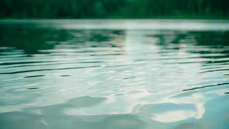 Calm-ripple-on-a-lake-water-surface-with-nature-background