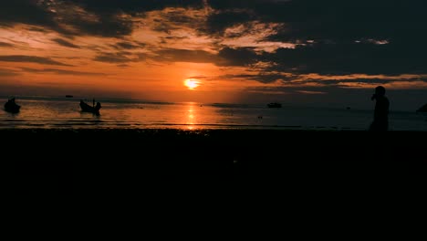 People-And-Boats-In-The-Stunning-Sairee-Beach-In-Koh-Tao,-Thailand---Sunset-To-Night-Motion-Timelapse
