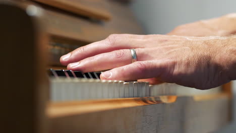 Close-up-of-male-hands-playing-piano