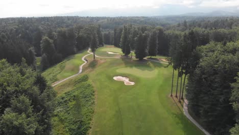 Drone-shot-of-a-golf-course-in-the-middle-of-the-forest-in-Slovenia