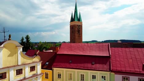 Aerial-rising-shot-of-the-town's-clocktower-in-Telc,-Czech-Republic