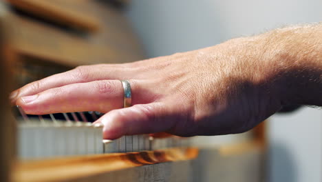 Close-up-of-Pianist-fingers-playing-piano,-slow-pan,-shallow-depth-of-field