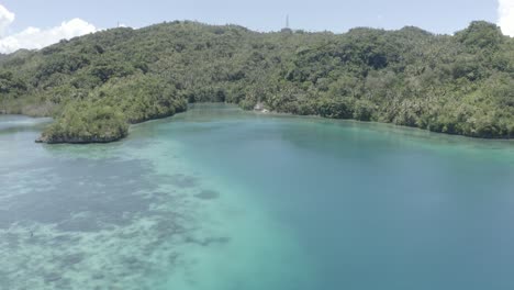 Ideal-Landscape-Scenery-Of-Bright-Blue-Lagoon-Surrounded-By-Lush-Green-Trees-In-A-Tropical-Island-In-The-Philippines---Tourist-Attraction---Aerial-Drone-Shot-View