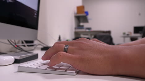 Married-man's-hands-typing-on-keyboard-in-modern-office