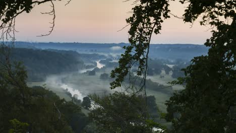Timelapse,-mist-swirling-over-the-Ruhr-river-valley-at-dawn,-high-angle