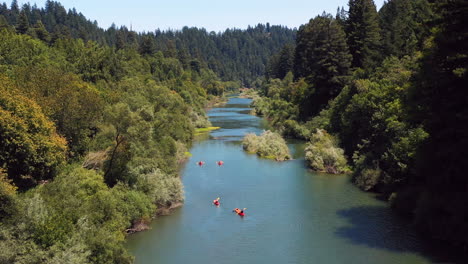 Aerial-view-of-kayakers-paddling-down-river-in-remote-wilderness-location