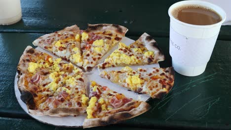 View-of-a-sliced-wood-fired-breakfast-pizza-and-coffee
