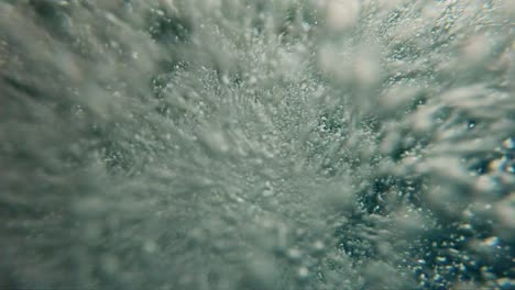 Аir-bubbles-floating-from-the-bottom-to-the-surface-of-the-water,-slow-motion
