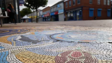 Shallow-focus-weathered-mosaic-broken-city-urban-sidewalk-closeup-dolly-right