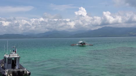Passenger-Boat-Cruising-Across-The-Beautiful-Sea-Of-Dos-Palmas-Island-Resort-In-Puerto-Princesa,-Palawan,-Philippines---Wide-Shot