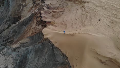 Man-standing-on-dune-cliff-in-Northern-Denmark