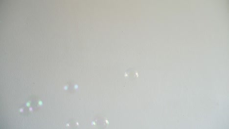 Slow-motion-of-blurred-soap-bubbles-on-a-white-background
