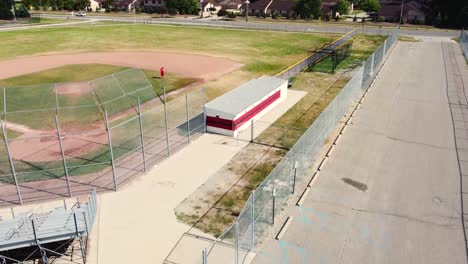 Short-clip-featuring-descending-drone-angle-of-a-baseball-diamond-at-a-high-school