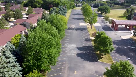 A-bird-eye's-view-over-a-parking-lot-of-a-suburban-middle-school