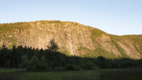 Sunlight-moves-down-mountain-peak-time-lapse,-Hillestad,-Norway